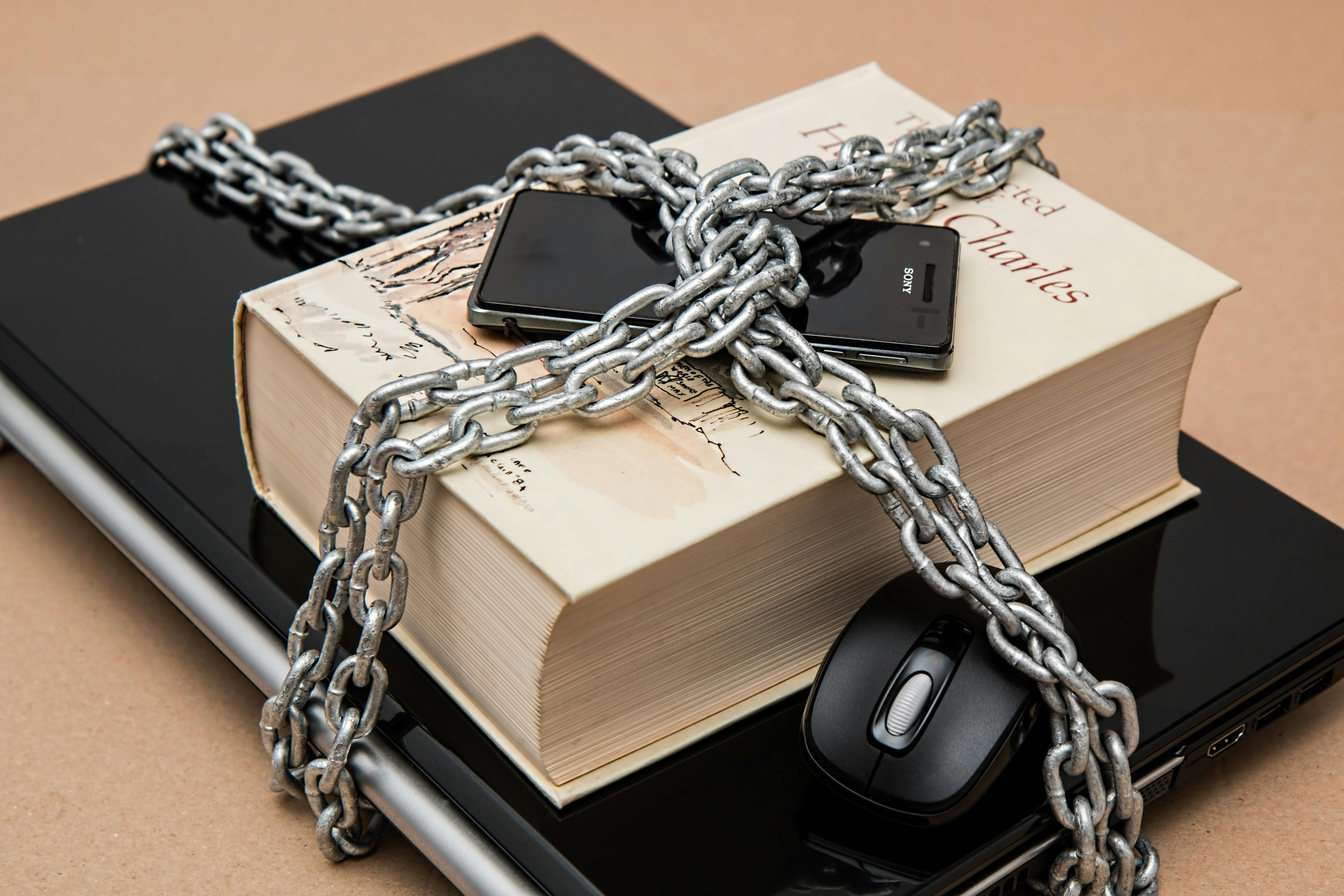 Books and phone up top chained together symbolizing Information Security